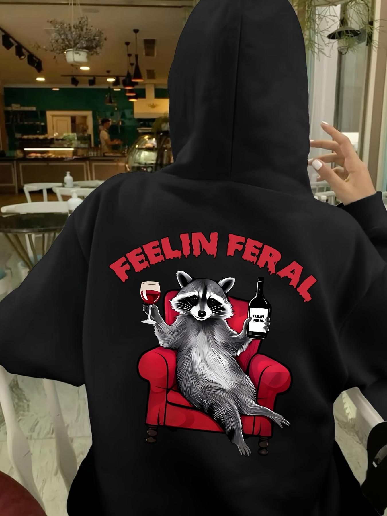 Tailorly Women's Printed Hoodie - Feelin Feral Relaxed Raccoon Lounging On Red Armchair With Wine And Bottle
