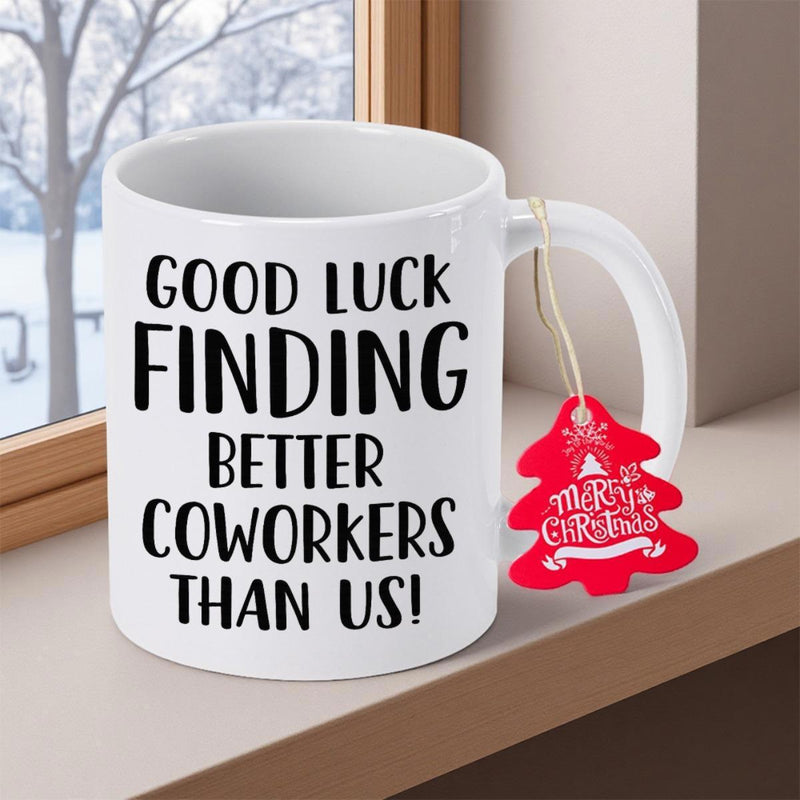 Tailorly White Ceramic 11 oz Mug - Good Luck Finding Better Coworkers Than Us Minimalist Typography On A Clean White Ceramic Background Beside A Window Mug