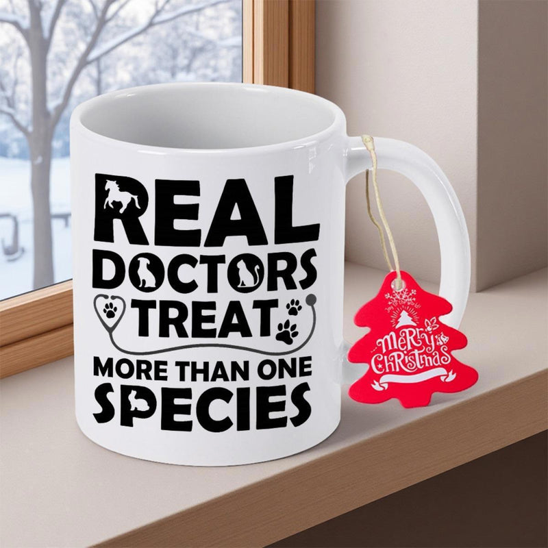 Tailorly White Ceramic 11 oz Mug - Real Doctors Treat More Than One Species Bold Black Lettering Featuring Heart Shaped Stethoscope With Animal Silhouettes Ceramic