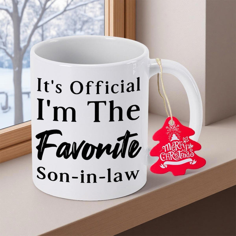 Tailorly White Ceramic 11 oz Mug - Its Official Im The Favorite Son In Law Ceramic Vessel With Decorative Red Holiday Tree Tag Attached Mug
