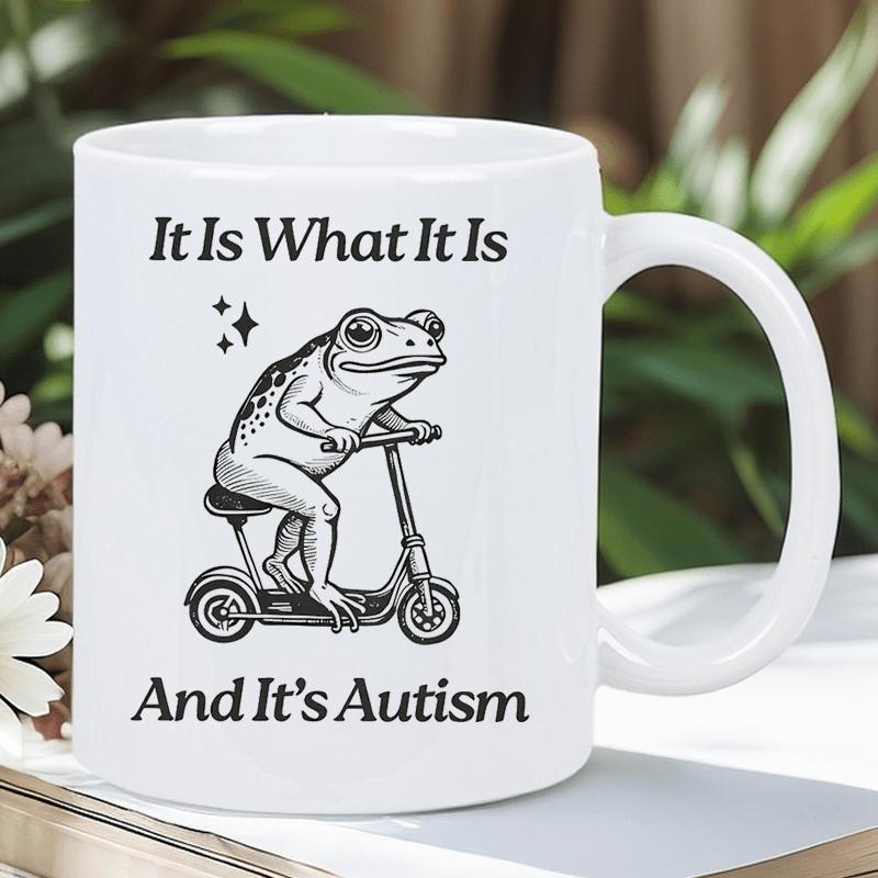 Tailorly White Ceramic 11 oz Mug - It Is What It Is And It's Autism Quirky Hand Drawn Character Riding A Small Scooter With Sparkle Elements Frog