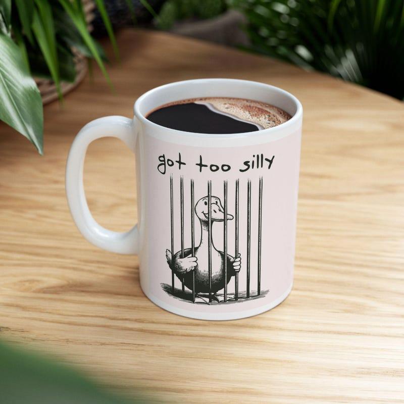 Tailorly White Ceramic 11 oz Mug - Got Too Silly Funny Cartoon Bird Trapped Behind Vertical Prison Bars With Hand Drawn Style Duck
