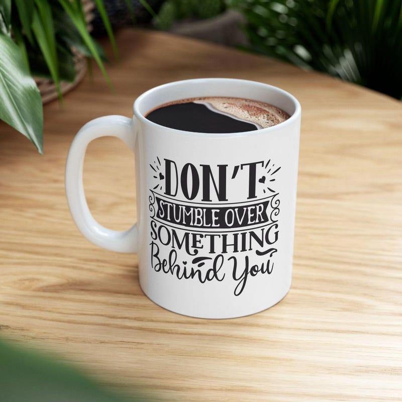 Tailorly White Ceramic 11 oz Mug - Dont Stumble Over Something Behind You Hand Lettered Quote With Elegant Decorative Flourishes And Scrolls Mug