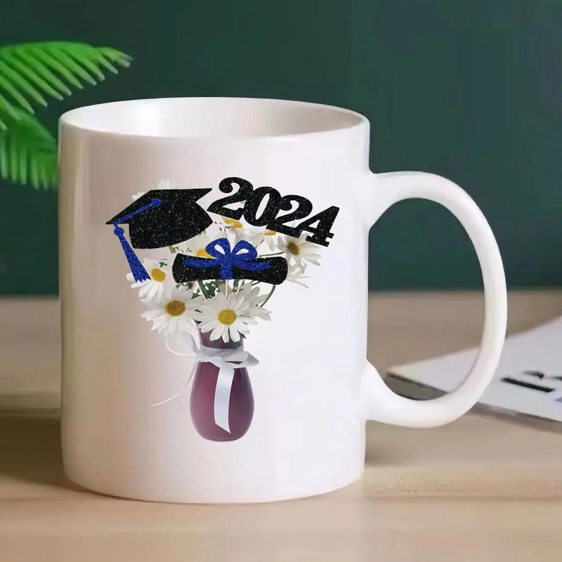 Tailorly White Ceramic 11 oz Mug - 2024 Graduation Mortarboard And Diploma Resting Upon White Daisy Bouquet Vase