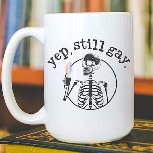 Tailorly White Ceramic 11 oz Mug - Yep Still Gay Artistic Skeleton Holding A Glowing Rainbow Torch Inside A Circle Skeleton
