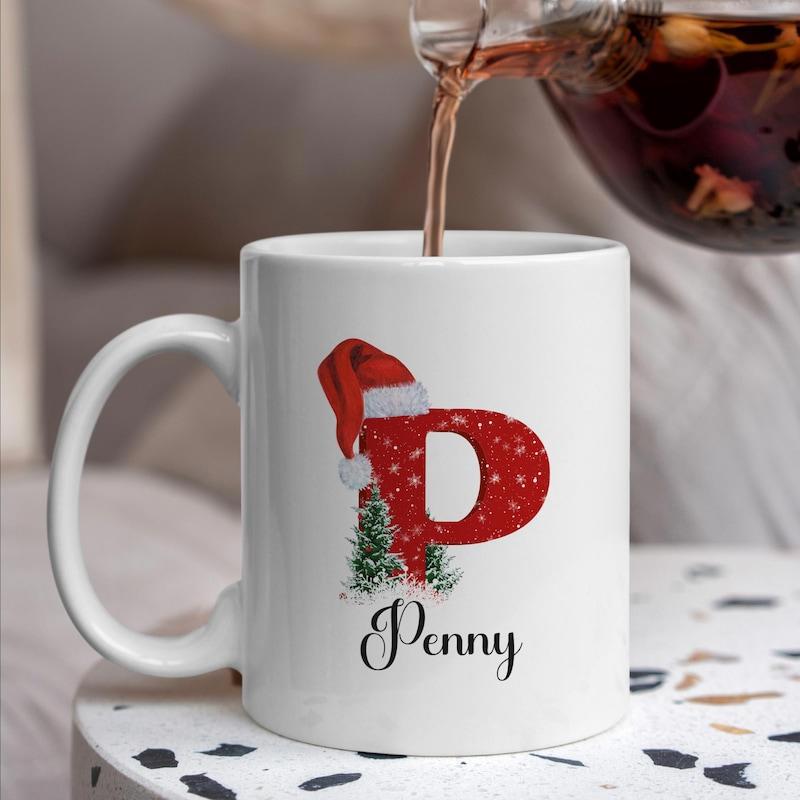 Tailorly White Ceramic 11 oz Mug - Penny Festive Red Letter With Santa Hat And Snowy Green Christmas Tree Mug