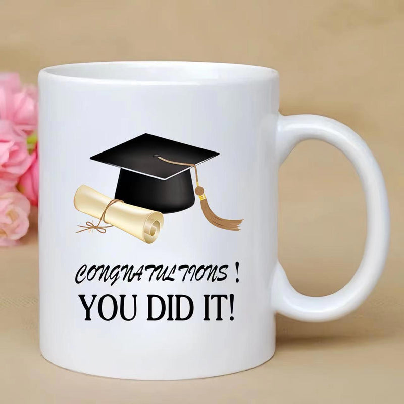 Tailorly White Ceramic 11 oz Mug - Congratulations You Did It Black Mortarboard With Golden Tassel Beside A Rolled Diploma Cap