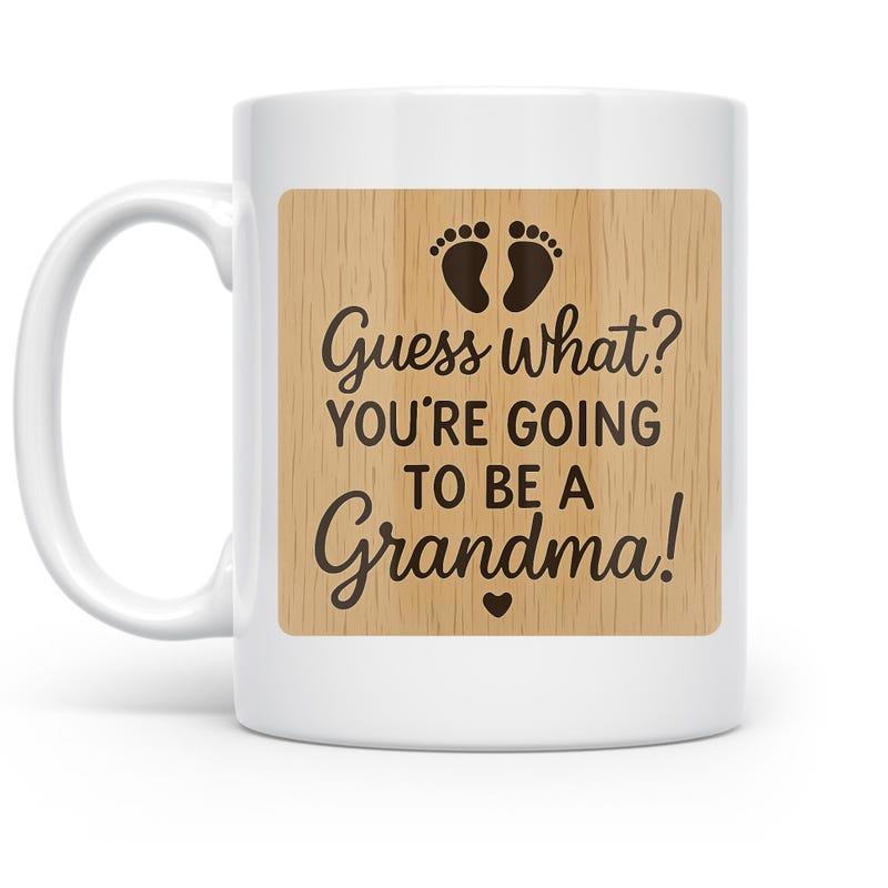 Tailorly White Ceramic 11 oz Mug - Guess What Youre Going To Be A Grandma Wood Grain Background Featuring Tiny Baby Footprints And A Small Heart Mug