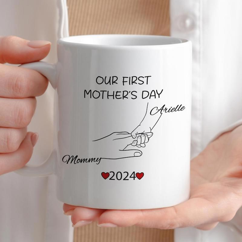 Tailorly White Ceramic 11 oz Mug - Our First Mothers Day Arielle Mommy 2024 Minimalist Line Drawing Of Parent Hand Gently Holding Infant Hand