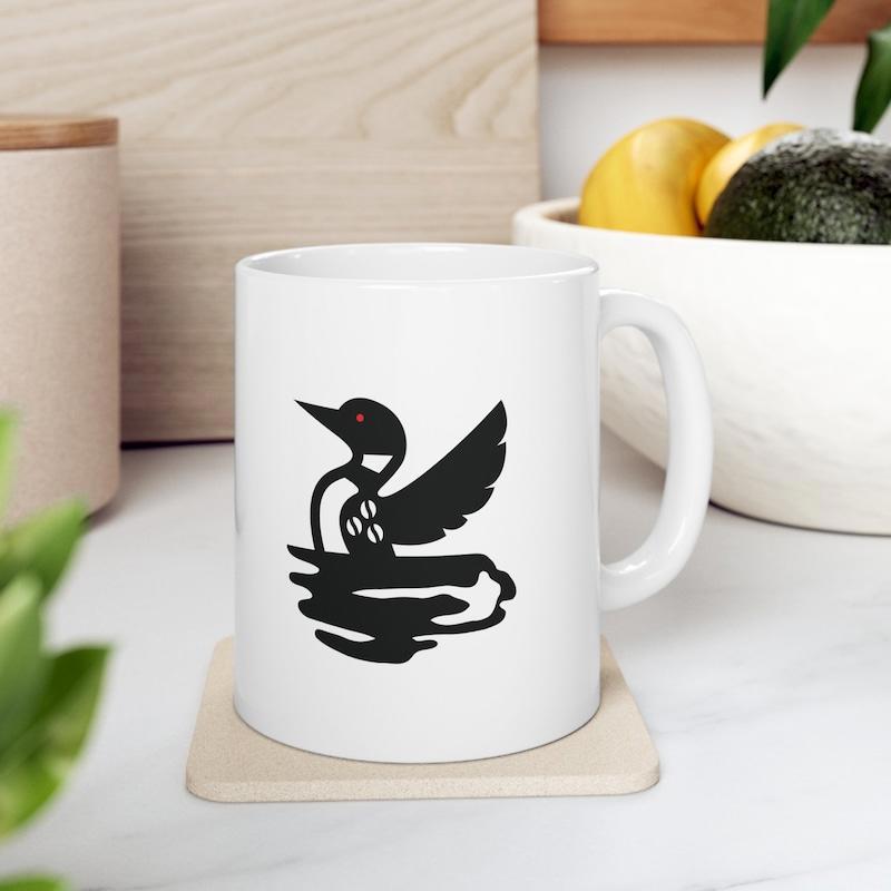 Tailorly White Ceramic 11 oz Mug - Majestic Silhouette Of A Loon Floating On Calm Rippling Lake Water Loon