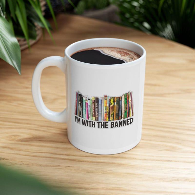 Tailorly White Ceramic 11 oz Mug - Im With The Banned Vintage Colorful Book Spines Standing In A Neat Horizontal Row Bookshelf