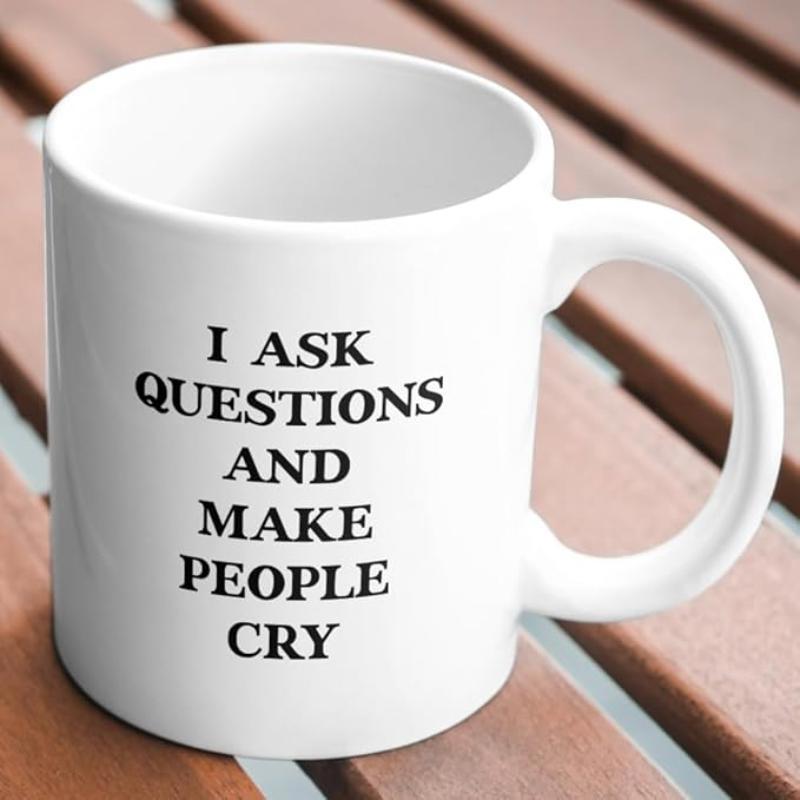 Tailorly White Ceramic 11 oz Mug - I Ask Questions And Make People Cry Minimalist White Ceramic Vessel Sitting Upon A Rustic Wooden Table Surface Mug