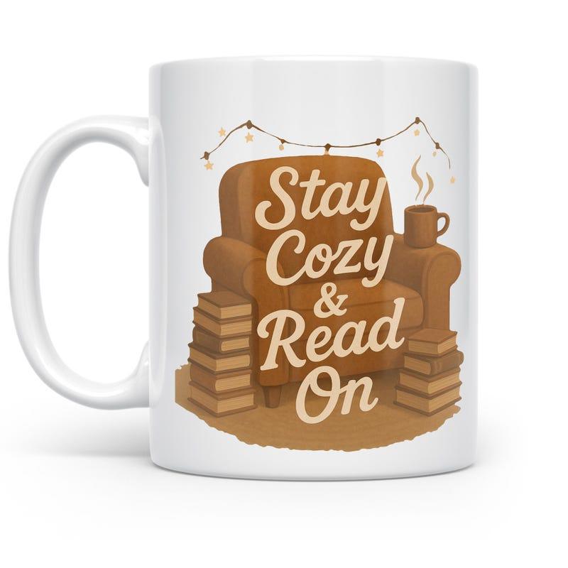 Tailorly White Ceramic 11 oz Mug - Stay Cozy Read On Warm Brown Armchair Surrounded By Stacks Of Books And Lights Armchair
