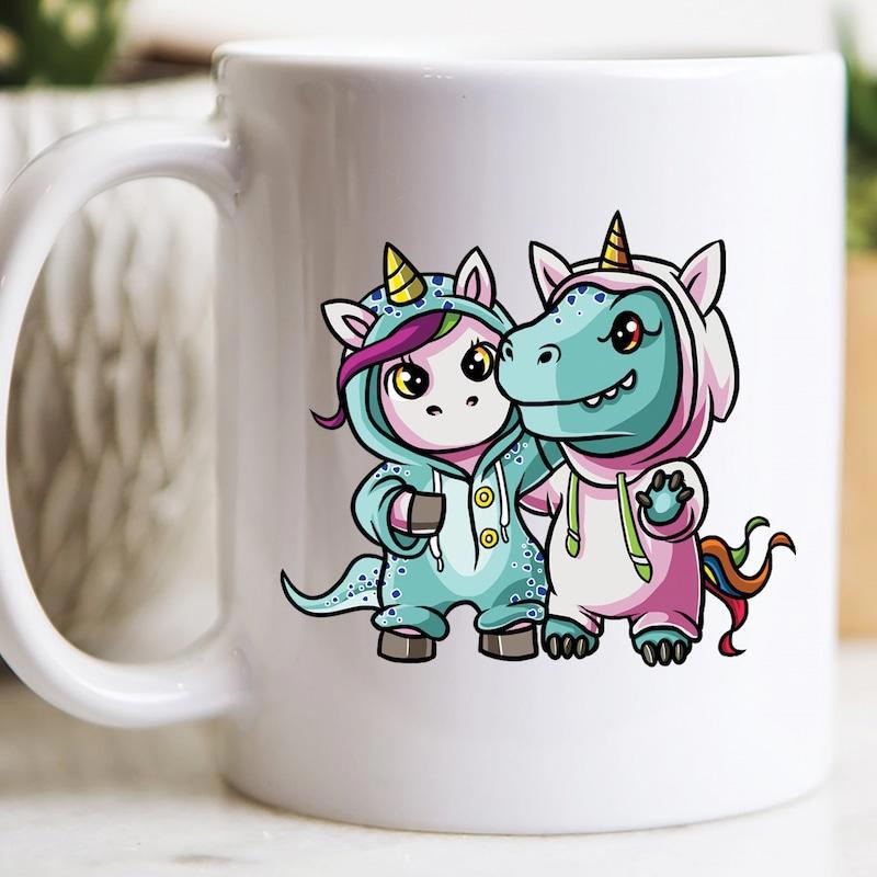 Tailorly White Ceramic 11 oz Mug - Two Adorable Mythical Friends Wearing Colorful Costume Onesies Standing Together Unicorn
