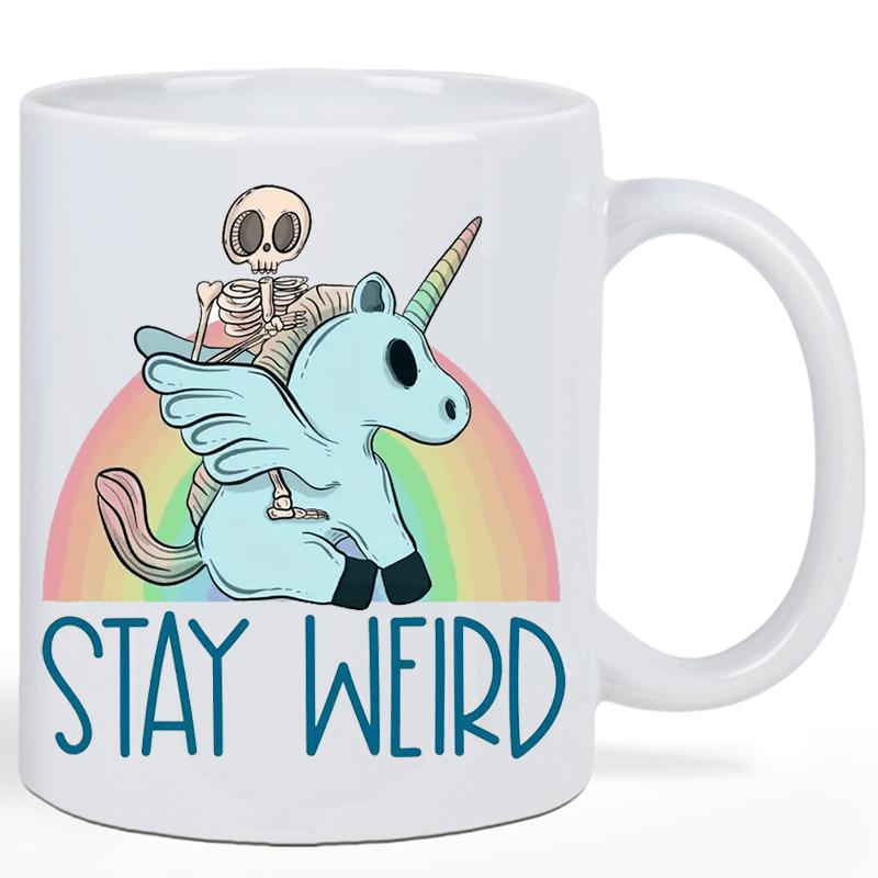 Tailorly White Ceramic 11 oz Mug - Stay Weird Skeletal Figure Riding A Winged Blue Creature Before Pastel Rainbow Unicorn