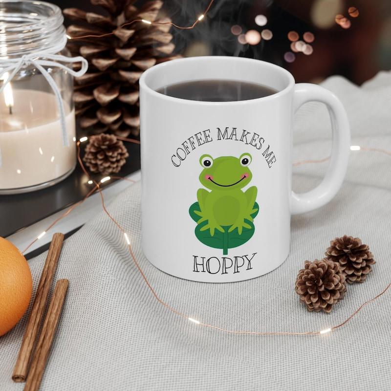 Tailorly White Ceramic 11 oz Mug - Coffee Makes Me Hoppy Smiling Green Cartoon Frog Sitting On A Green Lily Pad Frog
