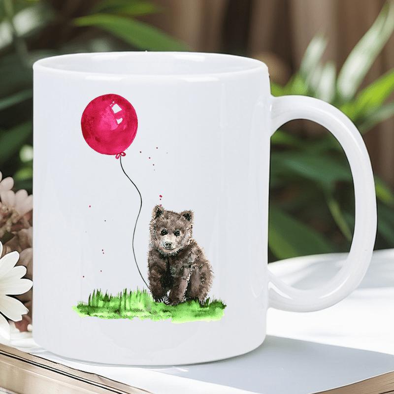 Tailorly White Ceramic 11 oz Mug - Small Brown Cub Sitting On Green Grass Holding Vibrant Red Balloon Bear