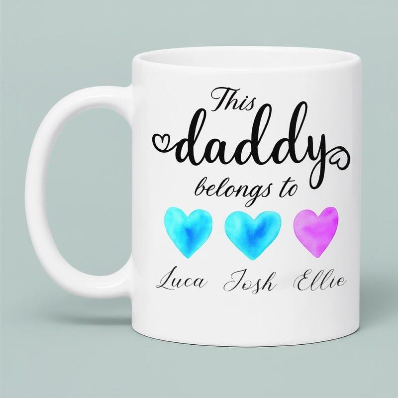 Tailorly White Ceramic 11 oz Mug - This Daddy Belongs To Luca Josh Ellie Three Colorful Watercolor Hearts Lined Up Between Rows Of Cursive Text Heart