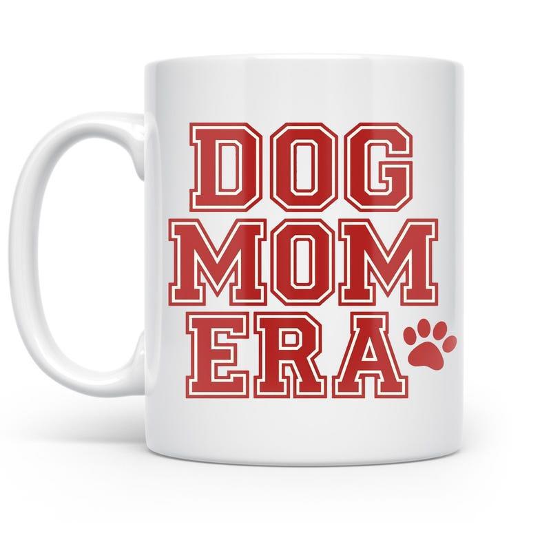 Tailorly White Ceramic 11 oz Mug - Dog Mom Era Bold Red Collegiate Lettering Beside A Cute Small Paw Print Mug