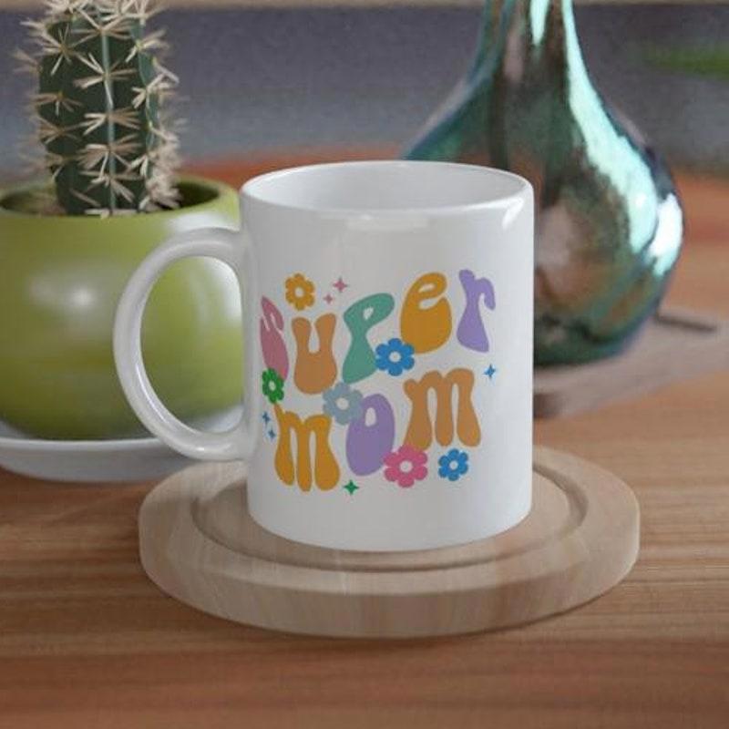 Tailorly White Ceramic 11 oz Mug - Super Mom Colorful Retro Groovy Lettering Surrounded By Vibrant Blossoms And Small Stars Mug