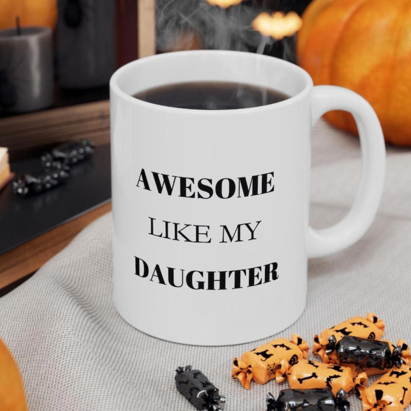 Tailorly White Ceramic 11 oz Mug - Awesome Like My Daughter Minimalist White Ceramic Vessel Sitting On A Textured Grey Fabric Mug