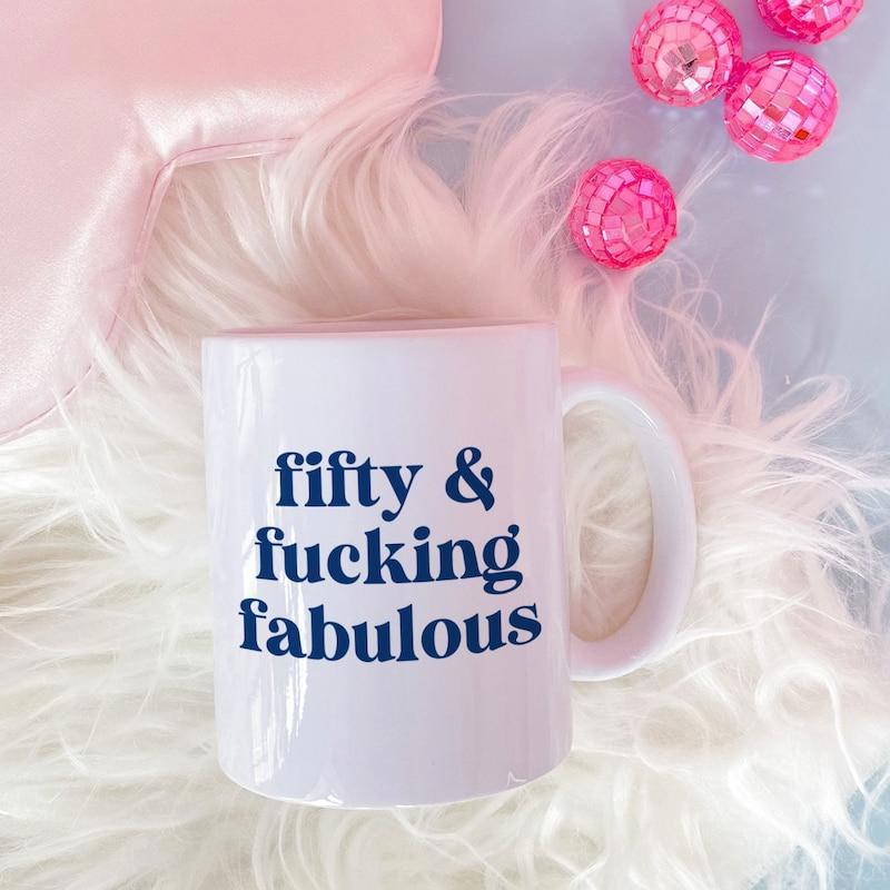 Tailorly White Ceramic 11 oz Mug - Fifty Fucking Fabulous Elegant White Ceramic Container Resting On Soft Pink Feathers Mug