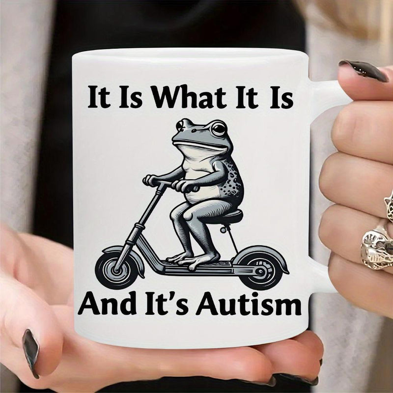 Tailorly White Ceramic 11 oz Mug - It Is What It Is And Its Autism Quirky Frog Riding A Small Black Electric Scooter With Focused Expression Frog
