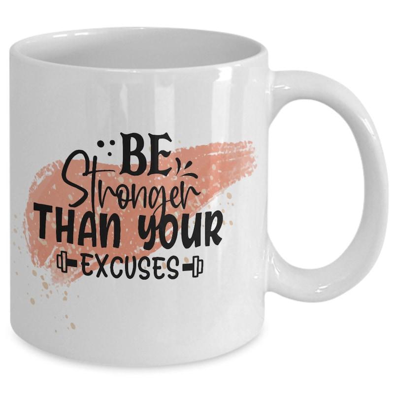 Tailorly White Ceramic 11 oz Mug - Be Stronger Than Your Excuses Elegant Rose Gold Brushstroke Background Featuring Motivational Fitness Text And Small Dumbbell