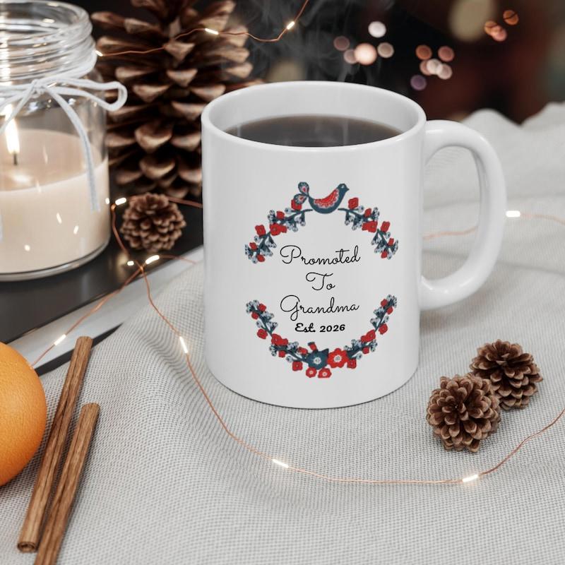 Tailorly White Ceramic 11 oz Mug - Promoted To Grandma Est 2024 Vibrant Floral Wreath With Decorative Birds And Small Berries Circling Text Mug