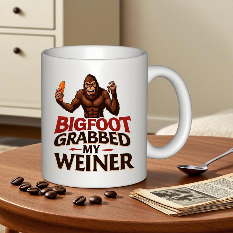 Tailorly White Ceramic 11 oz Mug - Bigfoot Grabbed My Weiner Muscular Brown Sasquatch Character Holding A Small Orange Hot Dog Bigfoot