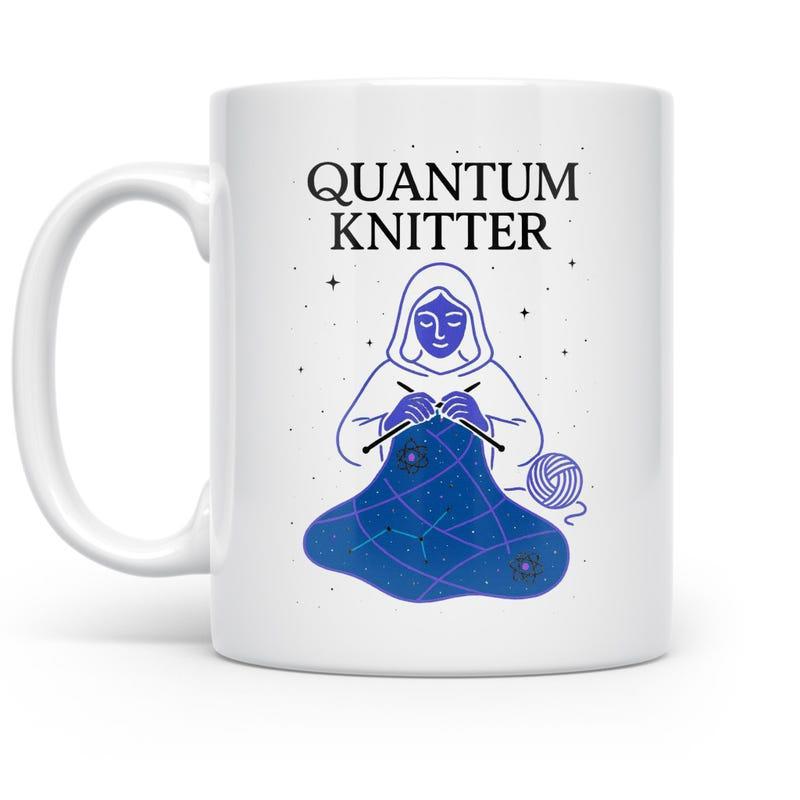 Tailorly White Ceramic 11 oz Mug - Quantum Knitter Hooded Figure Weaving A Glowing Galaxy Among Distant Cosmic Stars Knitter