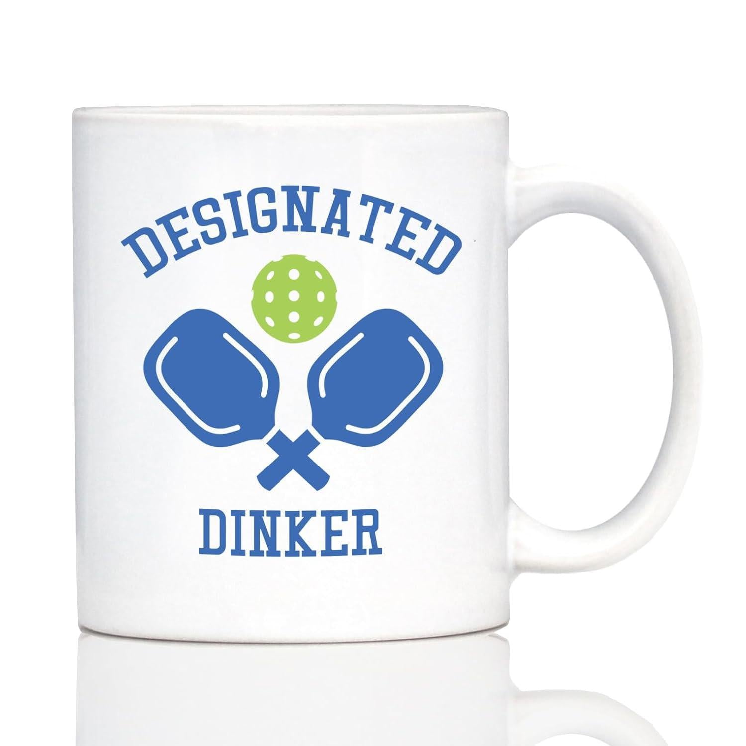 Tailorly White Ceramic 11 oz Mug - Designated Dinker Crossed Blue Sport Paddles With A Perforated Green Pickleball Paddle