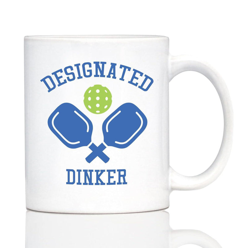 Tailorly White Ceramic 11 oz Mug - Designated Dinker Crossed Blue Sport Paddles With A Perforated Green Pickleball Paddle
