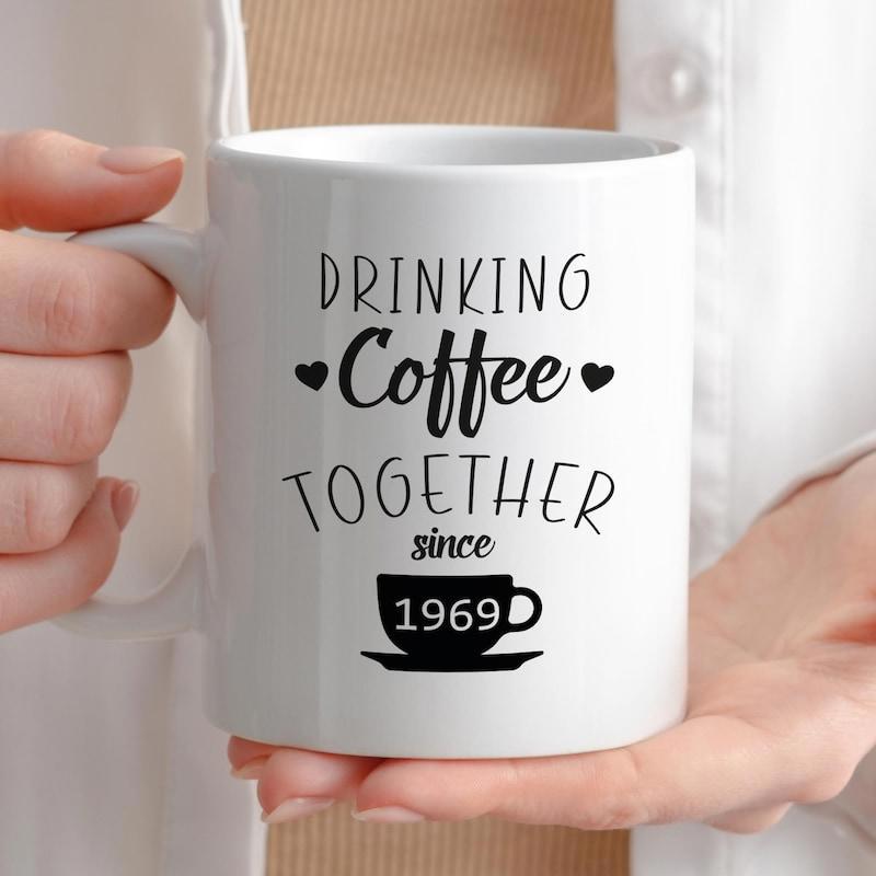 Tailorly White Ceramic 11 oz Mug - Drinking Coffee Together Since 1969 Elegant Steaming Coffee Cup With Charming Hearts Set Against Clean Background Cup