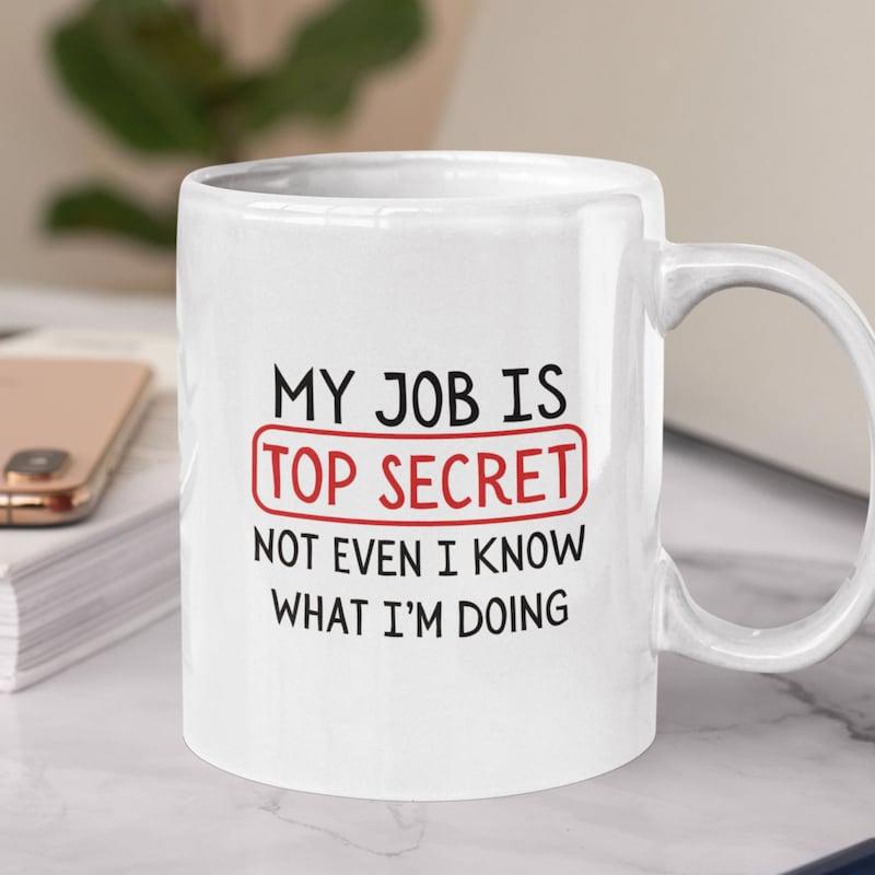 Tailorly White Ceramic 11 oz Mug - My Job Is Top Secret Not Even I Know What I'm Doing Minimalist Centered Text Within A Red Rectangular Frame On Smooth Surface
