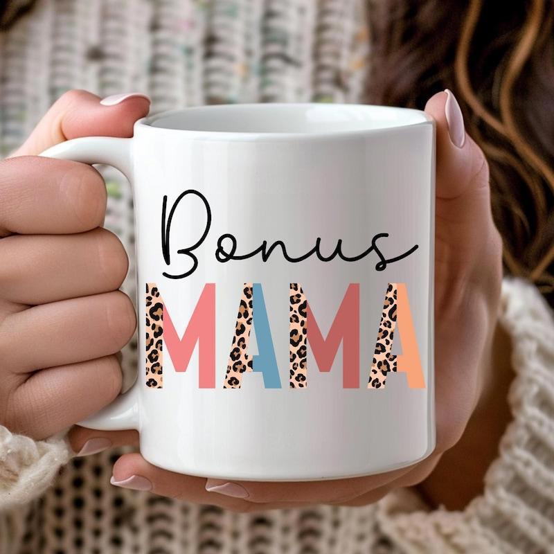 Tailorly White Ceramic 11 oz Mug - Bonus Mama Elegant Black Script Text Above Colorful Patterned Leopard Block Letters Pattern