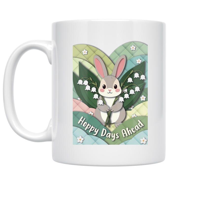 Tailorly White Ceramic 11 oz Mug - Hoppy Days Ahead Graceful Small Grey Surrounded By Blooming White Lily Of The Valley Bunny