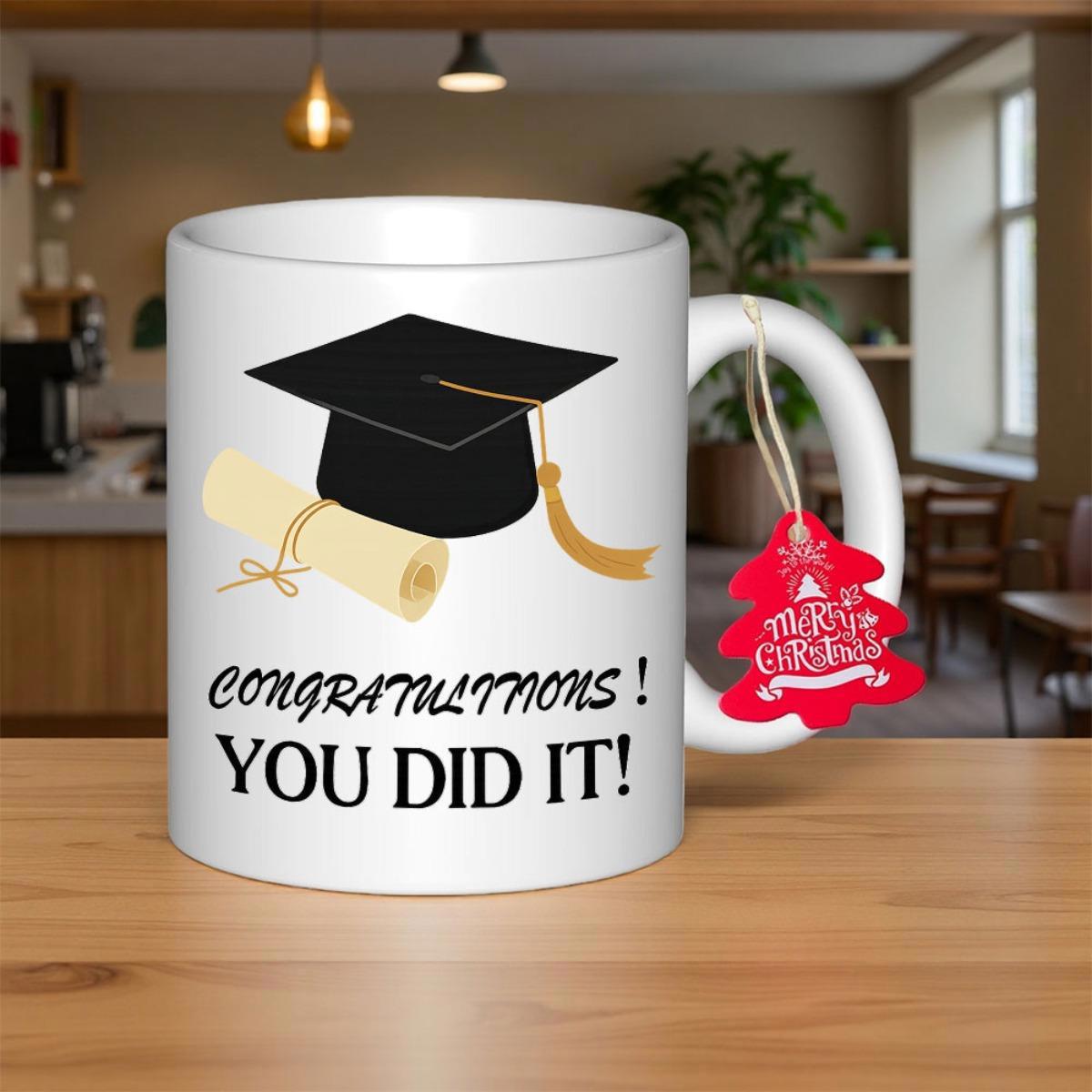Tailorly White Ceramic 11 oz Mug - Congratulations You Did It Black Academic Cap With Golden Tassel Beside A Rolled Paper Graduation Cap