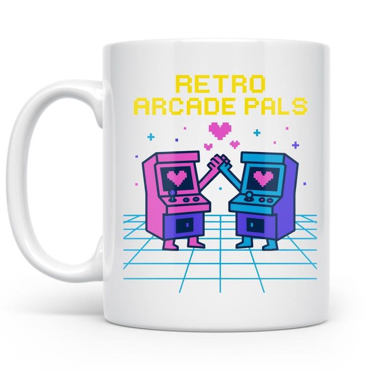 Tailorly White Ceramic 11 oz Mug - Retro Arcade Pals Two Stylized Retro Gaming Machines High Fiving With Hearts Above Arcade
