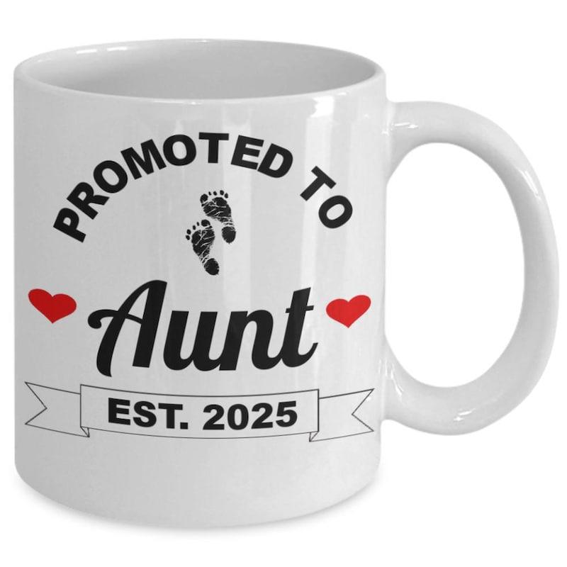 Tailorly White Ceramic 11 oz Mug - Promoted To Aunt Est 2025 Small Baby Footprints With Red Hearts Flanking Bold Script Text Aunt