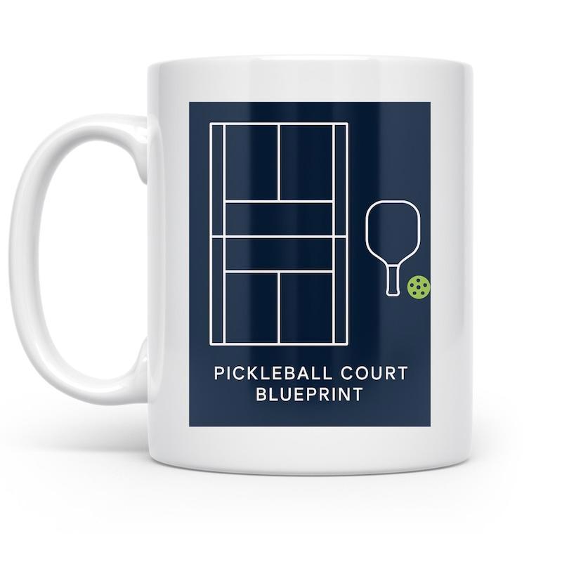 Tailorly White Ceramic 11 oz Mug - Pickleball Court Blueprint Minimalist White Line Illustration Featuring Sports Equipment On Navy Background Pickleball Court