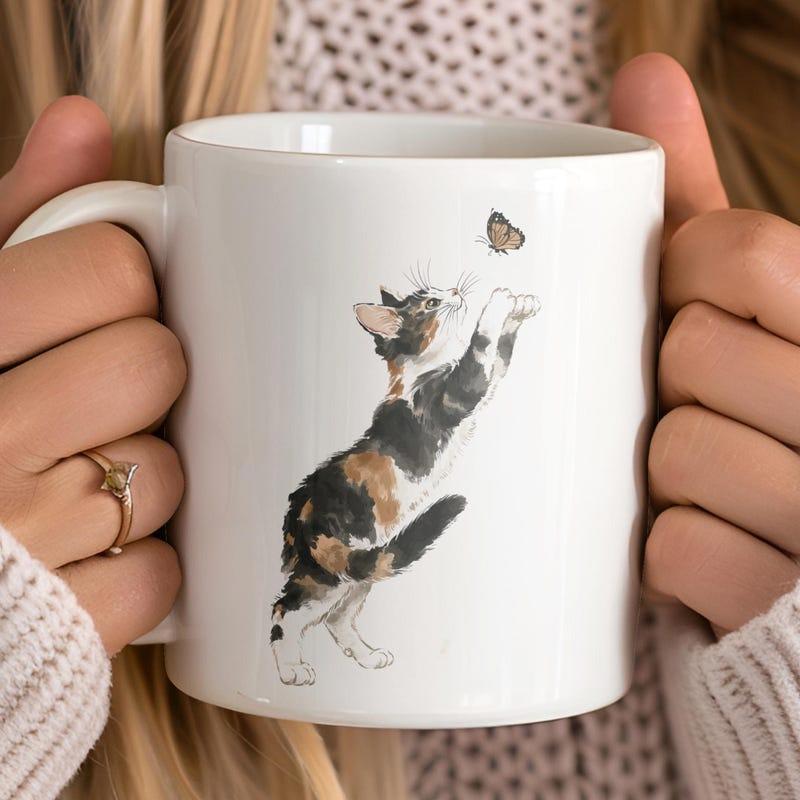 Tailorly White Ceramic 11 oz Mug - Playful Calico Watercolor Feline Reaching Towards A Small Flying Butterfly Cat