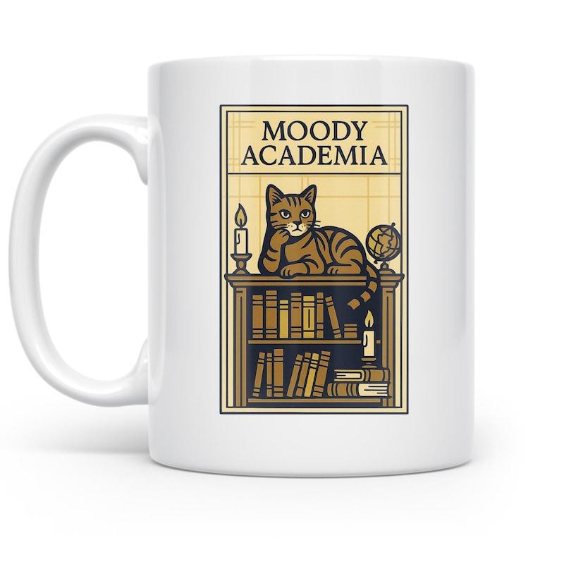 Tailorly White Ceramic 11 oz Mug - Moody Academia Tabby Cat Resting On Vintage Bookshelf Among Candles And Old World Globe Cat