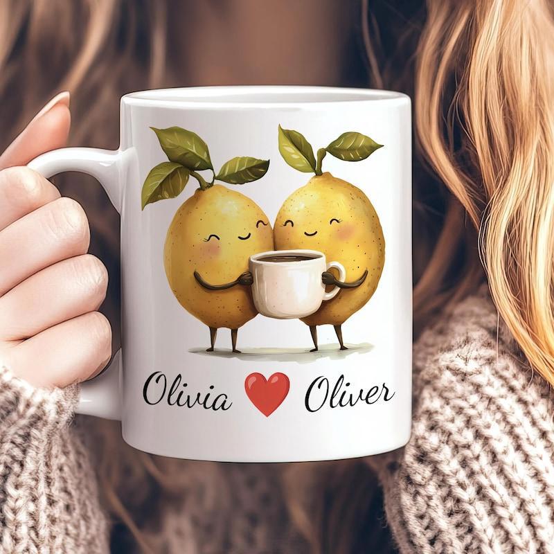 Tailorly White Ceramic 11 oz Mug - Olivia Oliver Two Cute Anthropomorphic Lemons Holding A Small Coffee Cup Together Lemons