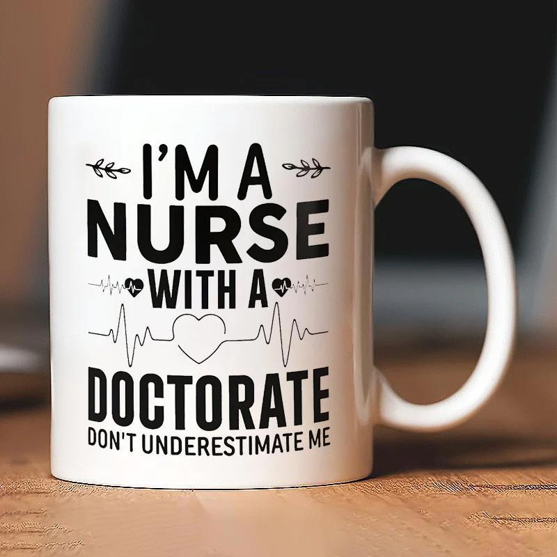 Tailorly White Ceramic 11 oz Mug - Im A Nurse With A Doctorate Dont Underestimate Me Minimalist Black Lettering Featuring Medical Heartbeat Lines And Elegant Leaf