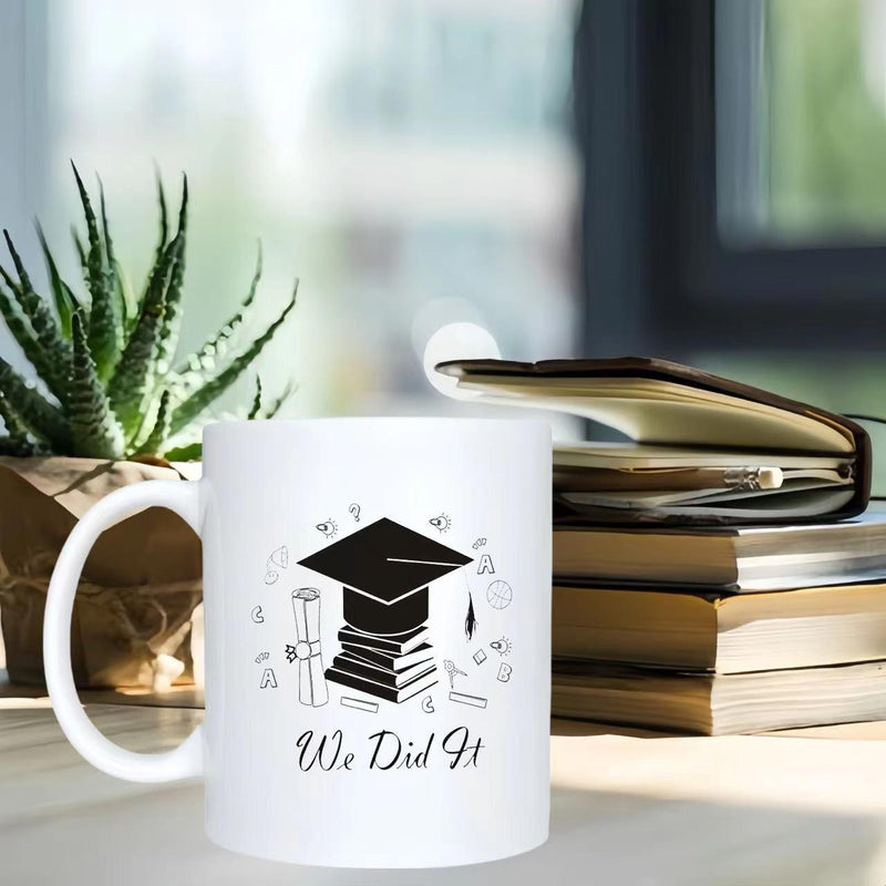Tailorly White Ceramic 11 oz Mug - We Did It Black Academic Cap Resting Upon Stacked Books Surrounded By Celebratory Sparkles Mortarboard