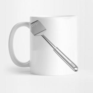 Tailorly White Ceramic 11 oz Mug - Shiny Metallic Kitchen Utensil Resting Against A Minimalist Plain White Ceramic Spatula
