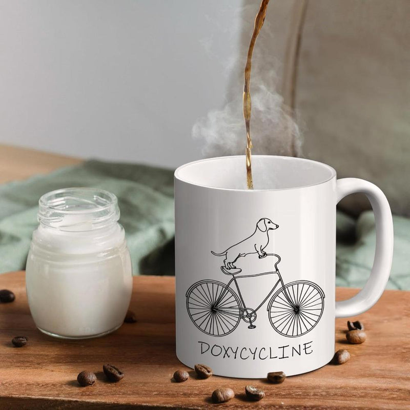 Tailorly White Ceramic 11 oz Mug - Doxycycline Minimalist Line Drawing Of A Dog Riding A Classic Bicycle Dachshund