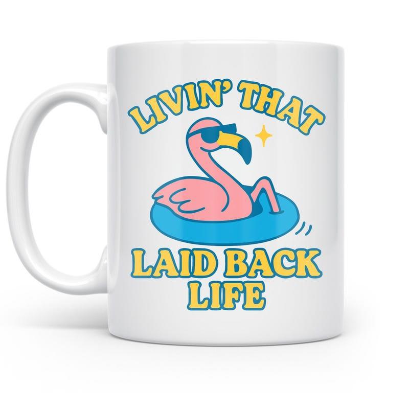 Tailorly White Ceramic 11 oz Mug - Livin That Laid Back Life Pink Bird Wearing Dark Sunglasses Floating On Blue Water Ring Flamingo