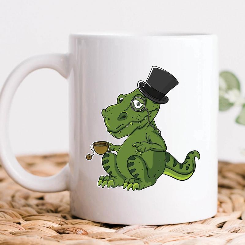 Tailorly White Ceramic 11 oz Mug - Distinguished Green Cartoon Dinosaur Wearing Top Hat Holding Small Tea Cup Dinosaur